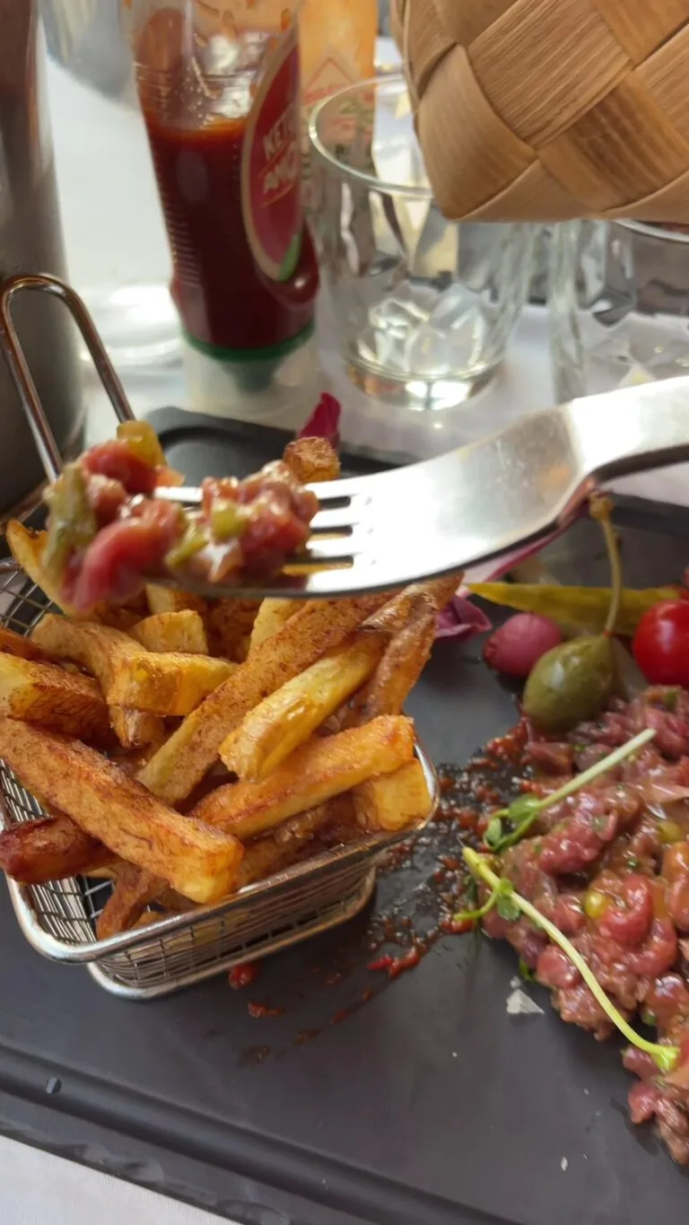 Beef tartare with golden chips and side dishes at the restaurant