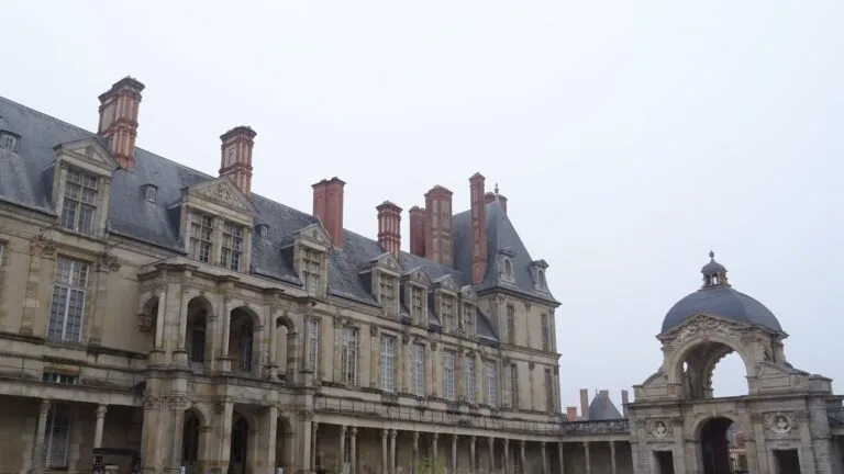 The façade of the Château de Fontainebleau with red-brick chimneys