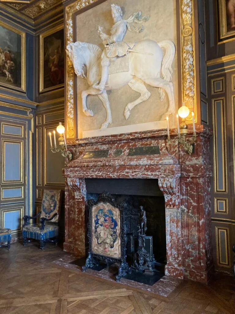 Marble fireplace with an equestrian bas-relief at the Palace of Versailles