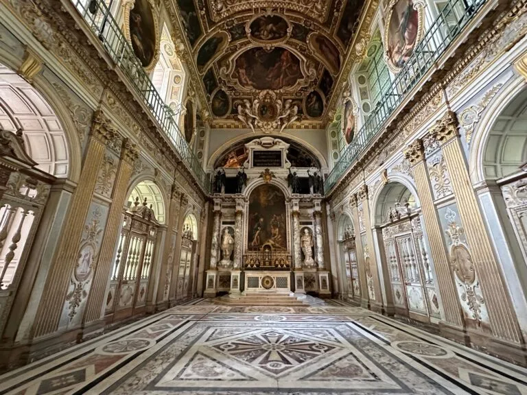 Baroque interior of a royal chapel with frescoes and marble