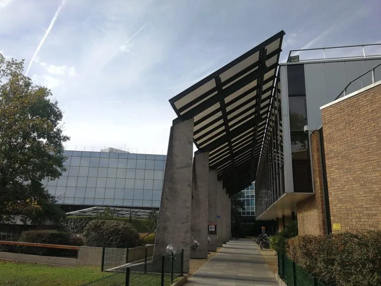 Entrance to a modern building with a metal canopy and a glass façade