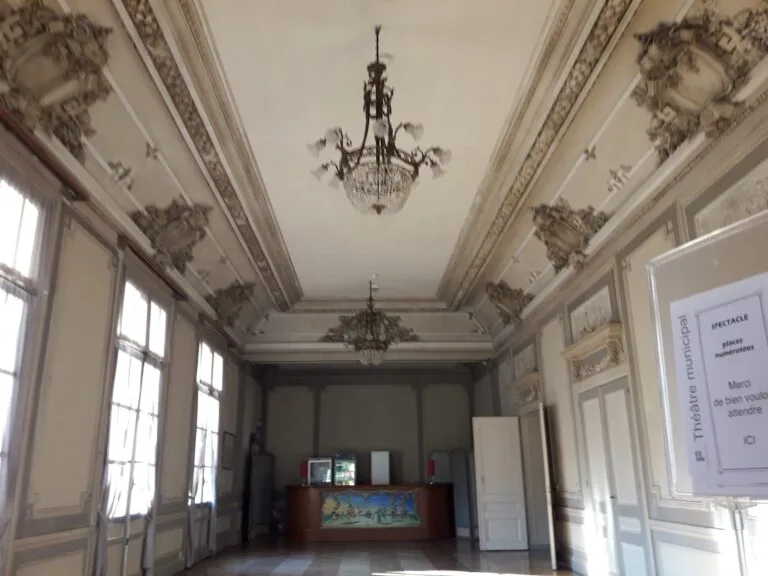 Entrance hall of the municipal theatre with chandeliers and gilded mouldings
