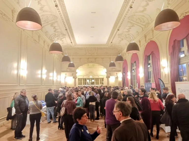 Networking event in an ornate and lively reception hall