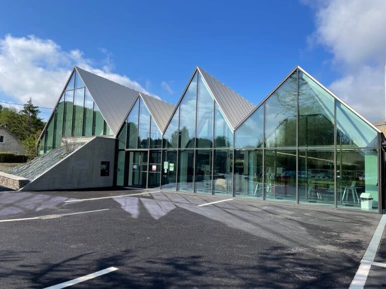 Contemporary façade of the Les Sources Vives multimedia library in Avon, architecture in glass and zinc with triangular roofs