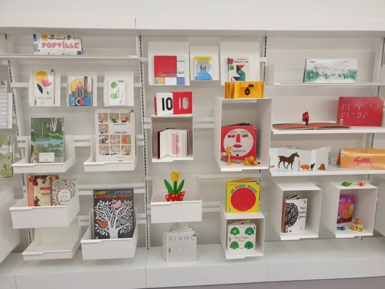 Illustrated books and children's albums section of the Les Sources Vives multimedia library in Avon, selection on white shelves