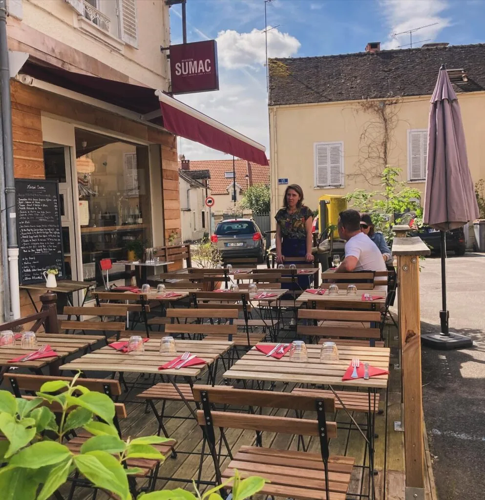 Maison Sumac terrace on the Place de la République in Samois-sur-Seine, wooden tables and burgundy sign