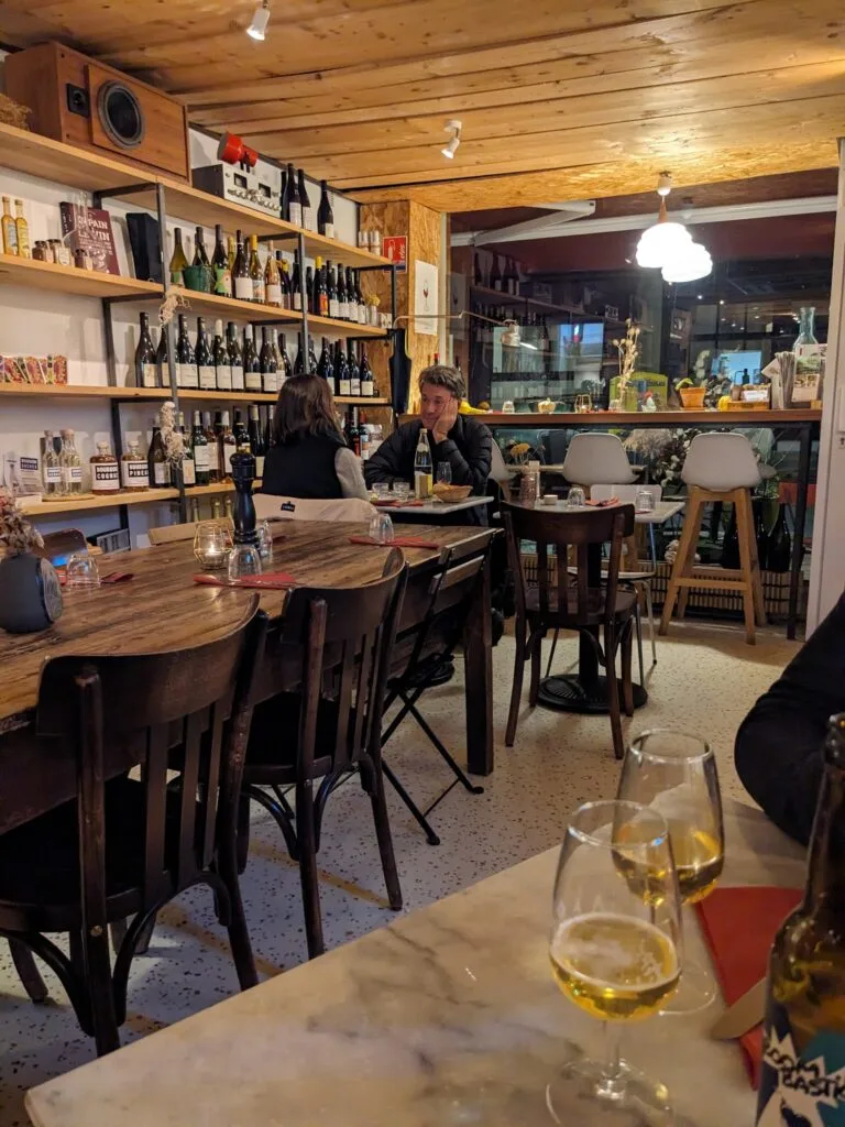 Maison Sumac interior room with bottle racks, wooden ceiling and wine cellar atmosphere