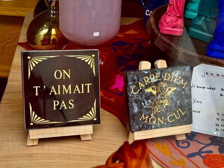 Humorous signs in the shop window of Maison Madeleine in Fontainebleau